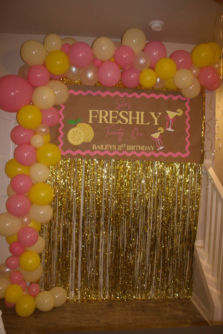 Freshly Twenty-One birthday backdrop with pink and yellow balloon arch
